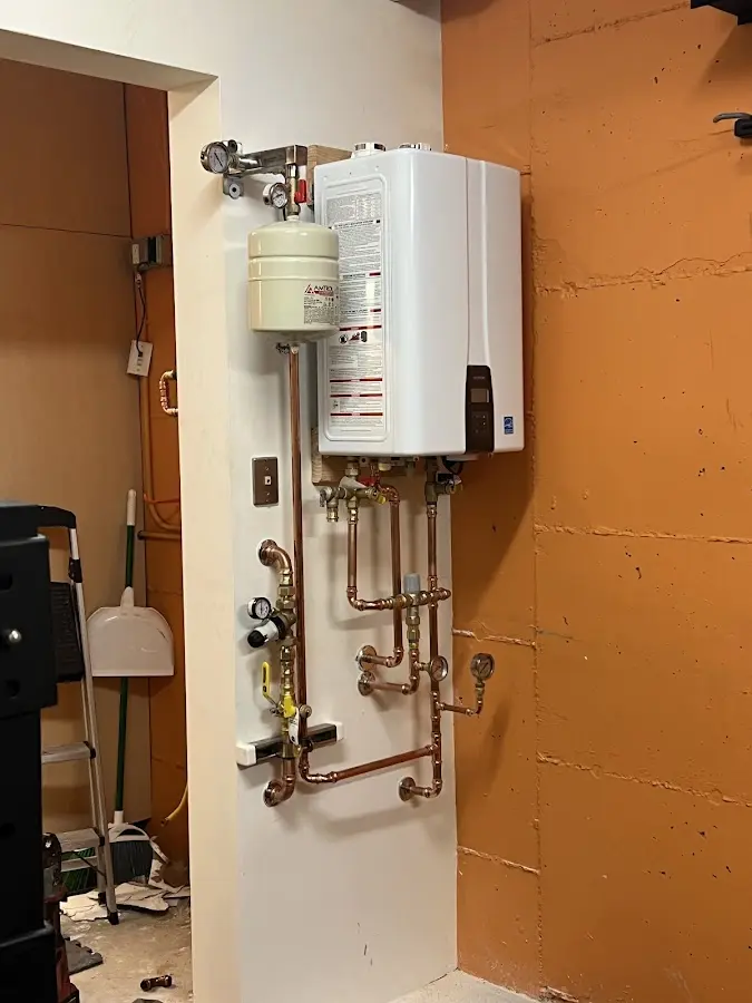 Plumbing technician inspecting water heater connections in Haverstraw